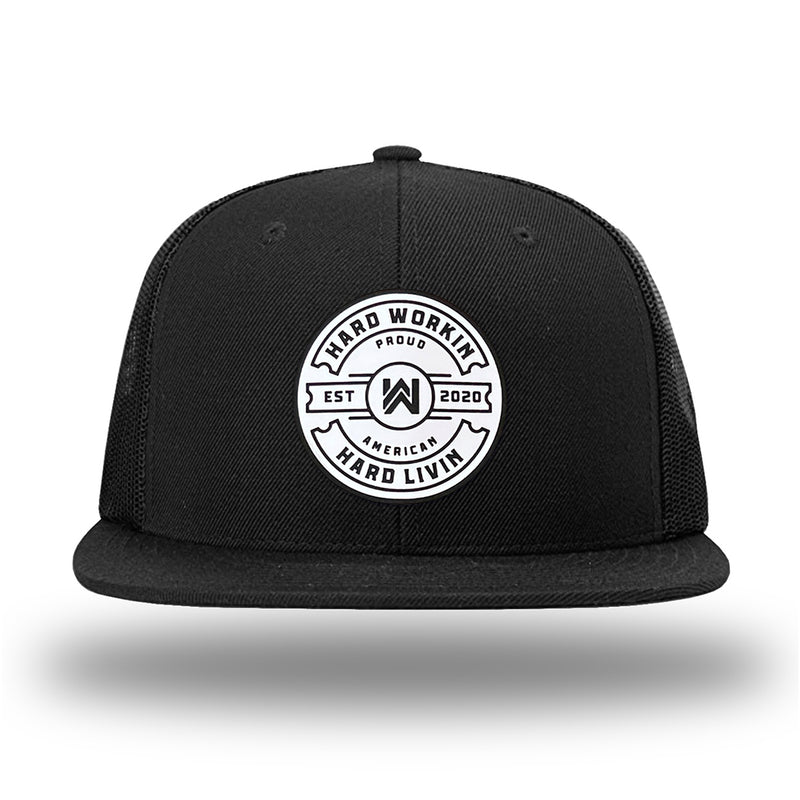 Solid Black WeWorkin hat—Richardson 511 brand snapback, flatbill trucker hat style. WeWorkin "HARD WORKIN. HARD LIVIN." Proud American silicone circle patch is centered on the front panels.
