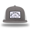 Charcoal/White WeWorkin hat—Richardson 511 brand snapback, flatbill trucker hat style. BLUE COLLAR DOLLAR ARCH (BCD-ARCH) woven patch with black merrowed edge, on a white background with black text, is centered on the front panels.