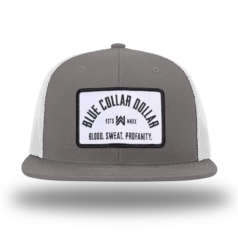 Charcoal/White WeWorkin hat—Richardson 511 brand snapback, flatbill trucker hat style. BLUE COLLAR DOLLAR ARCH (BCD-ARCH) woven patch with black merrowed edge, on a white background with black text, is centered on the front panels.