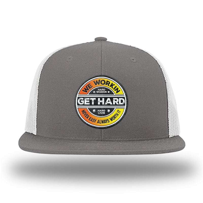Charcoal/White WeWorkin hat—Richardson 511 brand snapback, flatbill trucker hat style. WE WORKIN custom GET HARD patch made of thermoplastic, lightweight, durable material is centered on the front panels in orange to yellow fade and black colors.