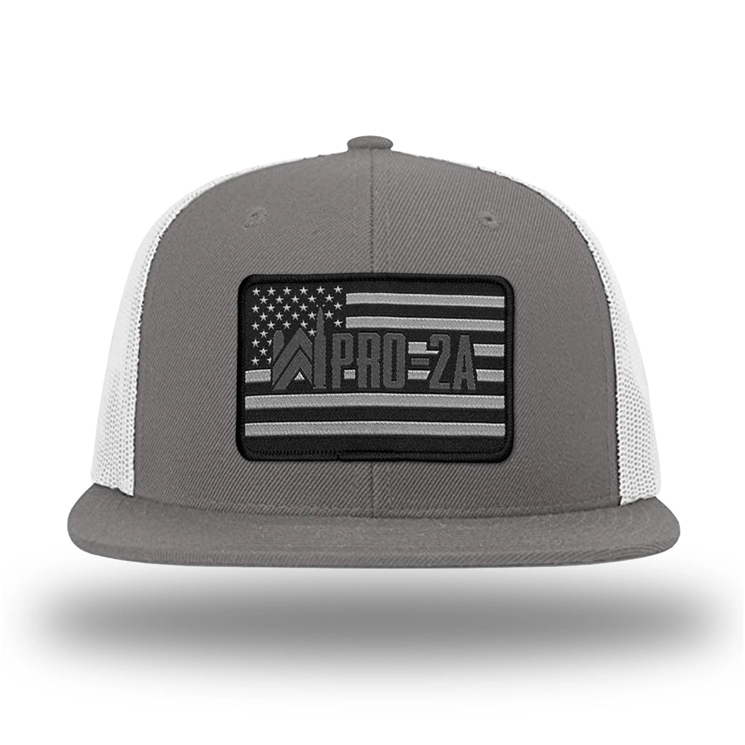 Charcoal/White WeWorkin hat—Richardson 511 brand snapback, flatbill trucker hat style. PRO-2A woven patch with black merrowed edge is centered on the front panels.