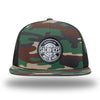 Green Camo/Black WeWorkin hat—Richardson 511 brand snapback, flatbill trucker hat style. WeWorkin "SACRIFICES Must Be Made" circular woven patch, with black/white thread colors and black merrowed edge, is centered on the front panels.