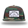 Green Camo/Black WeWorkin hat—Richardson 511 brand snapback, flatbill trucker hat style. BLUE COLLAR DOLLAR ARCH (BCD-ARCH) woven patch with black merrowed edge, on a white background with black text, is centered on the front panels.