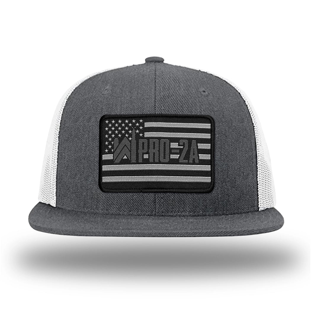 Heather Charcoal/White WeWorkin hat—Richardson 511 brand snapback, flatbill trucker hat style. PRO-2A woven patch with black merrowed edge is centered on the front panels.