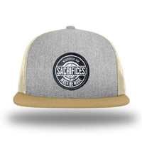 Heather Grey/Birch/Biscuit WeWorkin hat—Richardson 511 brand snapback, flatbill trucker hat style. WeWorkin "SACRIFICES Must Be Made" circular woven patch, with black/white thread colors and black merrowed edge, is centered on the front panels.