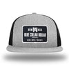 Heather Grey/Black WeWorkin hat—Richardson 511 brand snapback, flatbill trucker hat style. WeWorkin "Blue Collar Dollar" rectangle patch is centered large on the front panels. 