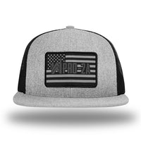 Heather Grey/Black WeWorkin hat—Richardson 511 brand snapback, flatbill trucker hat style. PRO-2A woven patch with black merrowed edge is centered on the front panels.
