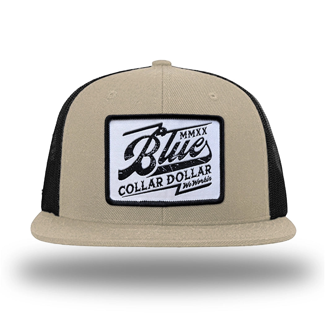 Khaki/Black WeWorkin hat—Richardson 511 brand snapback, flatbill trucker hat style. BLUE COLLAR DOLLAR VINTAGE (BCD-V) woven patch with black merrowed edge, on a white background with black, distressed text/design, centered on the front panels.