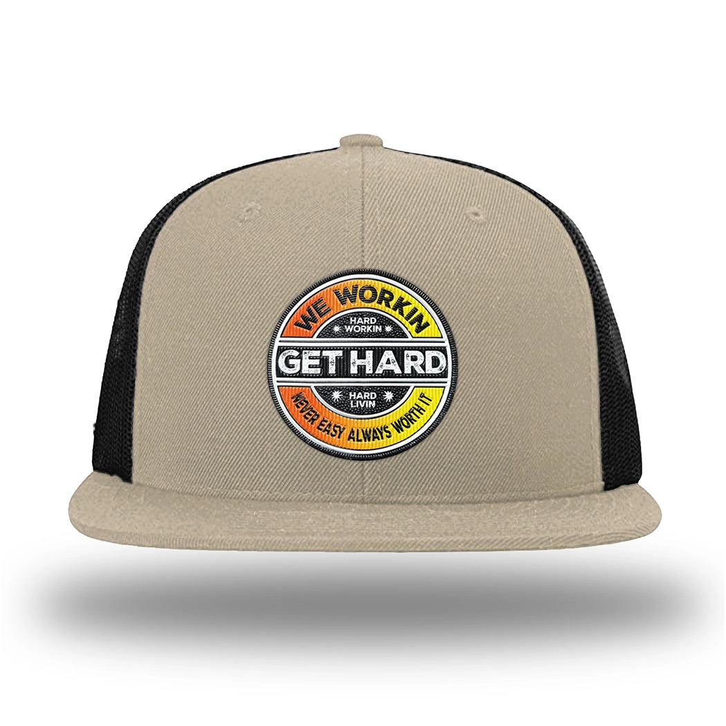 Khaki/Black WeWorkin hat—Richardson 511 brand snapback, flatbill trucker hat style. WE WORKIN custom GET HARD patch made of thermoplastic, lightweight, durable material is centered on the front panels in orange to yellow fade and black colors.
