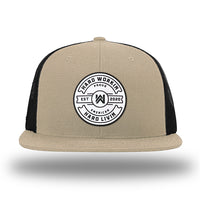 Khaki/Black WeWorkin hat—Richardson 511 brand snapback, flatbill trucker hat style. WeWorkin "HARD WORKIN. HARD LIVIN." Proud American silicone circle patch is centered on the front panels.