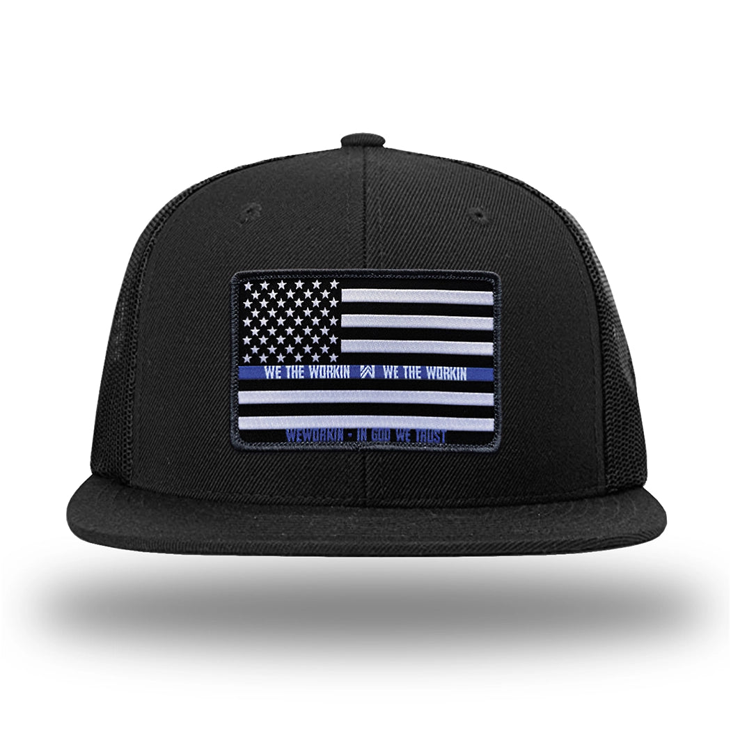 Solid Black WeWorkin hat—Richardson 511 brand snapback, flatbill trucker hat style. LEO FLAG woven patch with black merrowed edge is centered on the front panels.