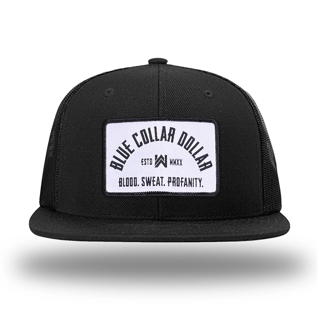 Solid Black WeWorkin hat—Richardson 511 brand snapback, flatbill trucker hat style. BLUE COLLAR DOLLAR ARCH (BCD-ARCH) woven patch with black merrowed edge, on a white background with black text, is centered on the front panels.