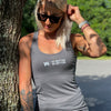 Woman pictured from front wearing a WEWORKIN racerback tank top in grey, with WEWORKIN WW icon on left and DO BETTER BE BETTER text stacked to the right imprinted small in white ink on the chest.