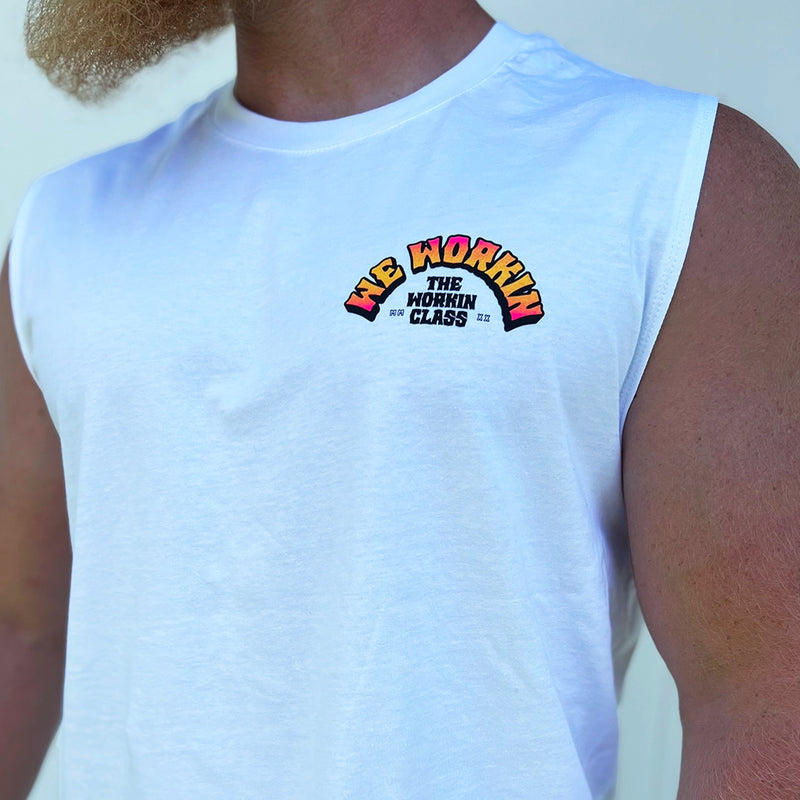 Man pictured from front, wearing a We Workin muscle tank in white. 3-color BARBELL CREW design in Neon Pink to Bright yellow fade and black, "WE WORKIN" main text is arched over top of "THE WORKIN CLASS" text MMXX—design is printed small in the left chest "pocket" area.