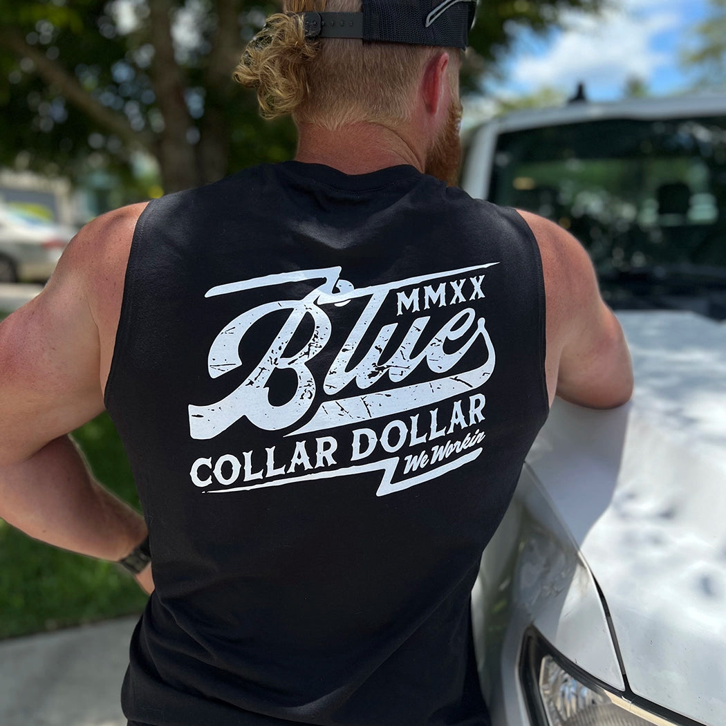 Man wearing a WW black muscle tank, shown from back. Blue Collar Dollar "Vintage" text graphic is printed large in the center/upper back area, in white ink.
