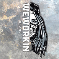 WEWORKIN BRAND black and white Women's SKULL Decal—Custom die-cut Direct Transfer window sticker on scratched metal background.
