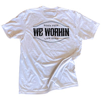 Back of a WW white tee on a white background. "Born Free WE WORKIN Live Hard" text on 3 lines with curved rope design on the top and bottom of the text, printed large in the center/upper back, in grey and black ink.