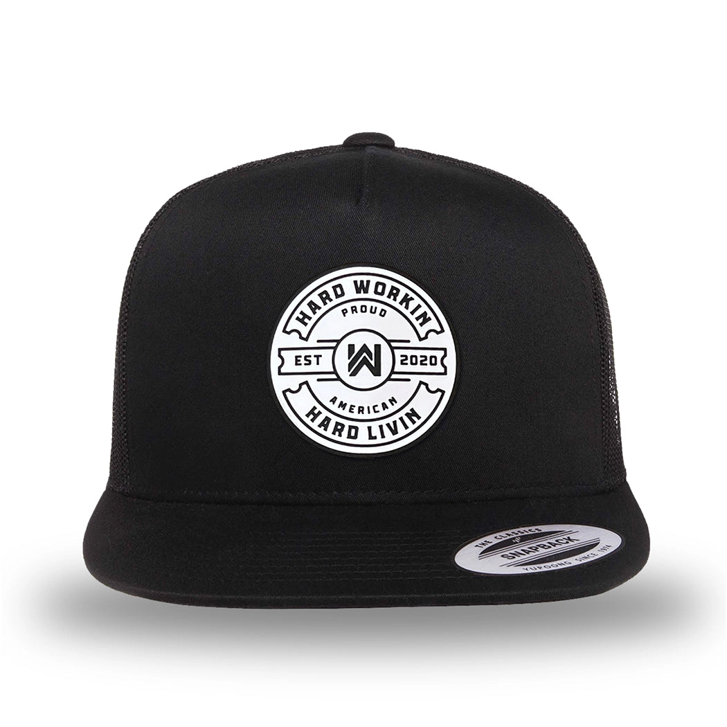 All black, high-profile, WeWorkin hat—snapback, 5-panel classic trucker, mesh sides/back style. WeWorkin "Hard Workin. Hard Livin. Proud American." circular silicone patch is centered on the front panel.