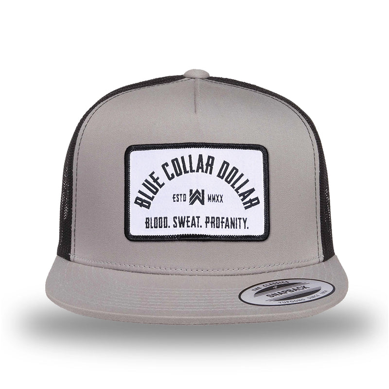 Silver/Black two-tone WeWorkin hat—snapback, 5-panel classic trucker, mesh sides/back style. We Workin "Blue Collar Dollar Arch" (BCD-ARCH) woven patch with black merrowed edge, on a white background with black text, is centered on the front panel.