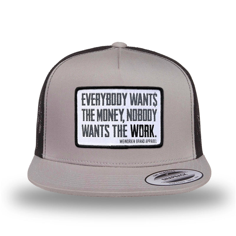 Silver/Black two-tone WeWorkin hat—snapback, 5-panel classic trucker, mesh sides/back style. WeWorkin "Everybody Want$ the Money, Nobody Wants the WORK." [white bkgd] rectangular woven patch is centered on the front panel.