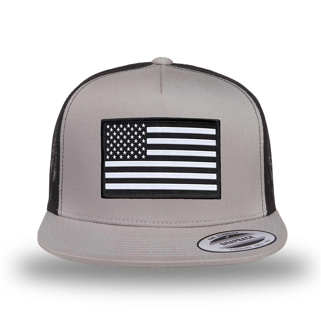 Silver/Black two-tone WeWorkin hat—snapback, 5-panel classic trucker, mesh sides/back style. WeWorkin "American Flag" rectangular patch is centered on the front panel.