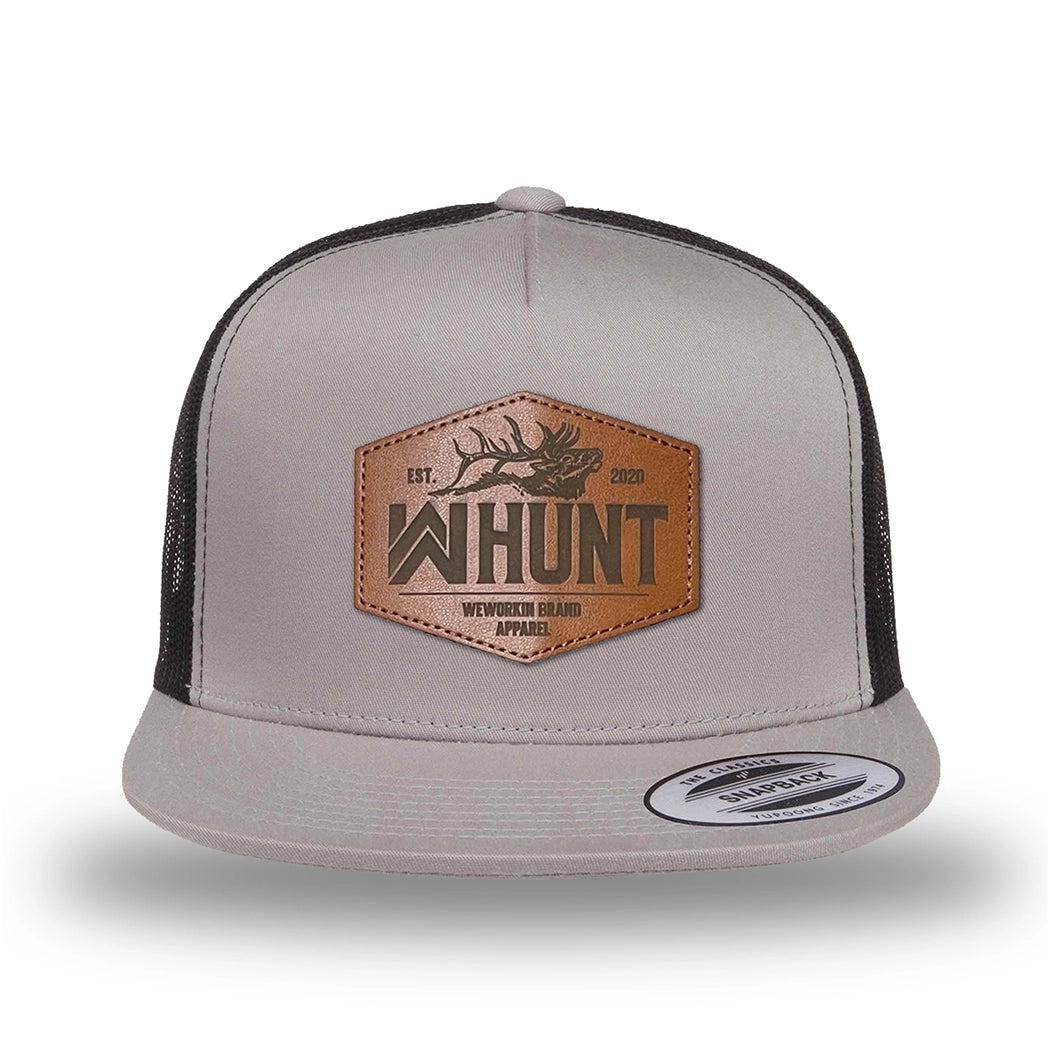 Silver/Black two-tone WeWorkin hat—snapback, 5-panel classic trucker, mesh sides/back style. WeWorkin "WW HUNT" etched leather patch with stitched border is centered on the front panel.
