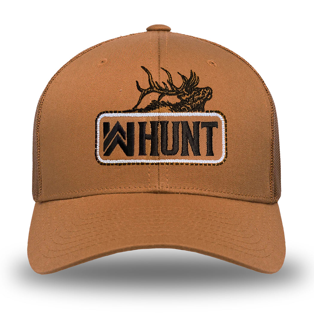 Picture of our WW HUNT trucker hat in Caramel color on white background. Embroidered with WW HUNT and ELK in our signature "patch" style across the front (WW icon/text/elk graphic in black thread, outer outline in black thread, inner "rope" in white thread). Front 2 panels and bill are caramel color, side/back mesh panels are caramel color.