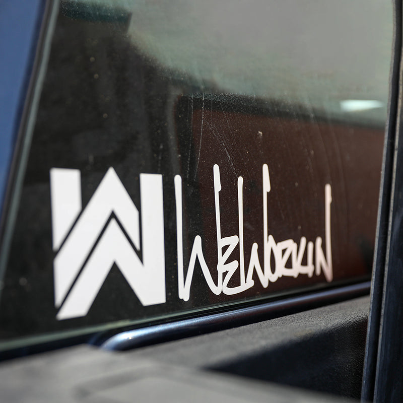 WeWorkin Icon/Script Logo Direct Transfer window decal in white, on rear window (lower left) of work truck.
