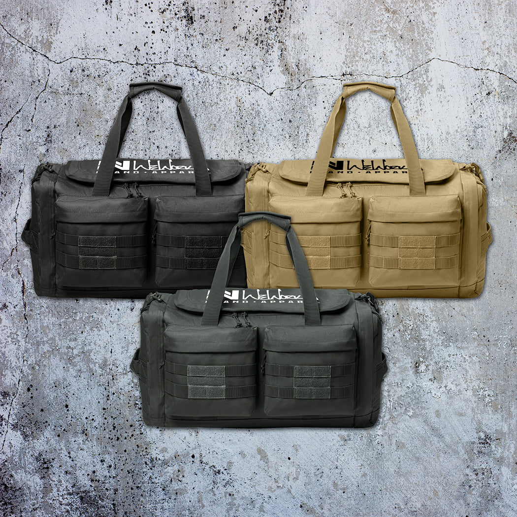 Stealth Black, Desert Tan and Charcoal Grey tactical duffle bags pictured from front on a grunge concrete background. WW Script logo embroidered in white and black threads on the top panel. 600D polyester canvas, Covered zipper D-shaped main compartment, [2] zippered end pockets, [2] Front zippered pockets with daisy chain/loop panels for patches (WW patches sold separately).