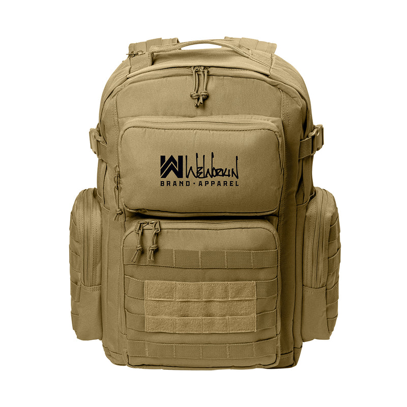 Desert Tan tactical backpack pictured from front on white background. WW Script logo embroidered in white thread on the top front pocket center. Two side zippered accessory pockets with daisy chain, Top front zippered pocket embroidered, Web carry handle, Lower front zippered pocket with daisy chain and loop panel for badges and patches.
