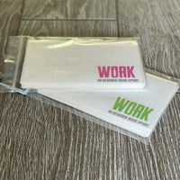 Two Stacks of the new WW Clear Stickers ("EVERYBODY WANT$ THE MONEY, NOBODY WANTS THE" words in white letters—"WORK" word highlighted in Neon Pink and Lime Green). Contained in (2) ziplock pouches, packs of 25 for each color, are laying on a grey tile floor.