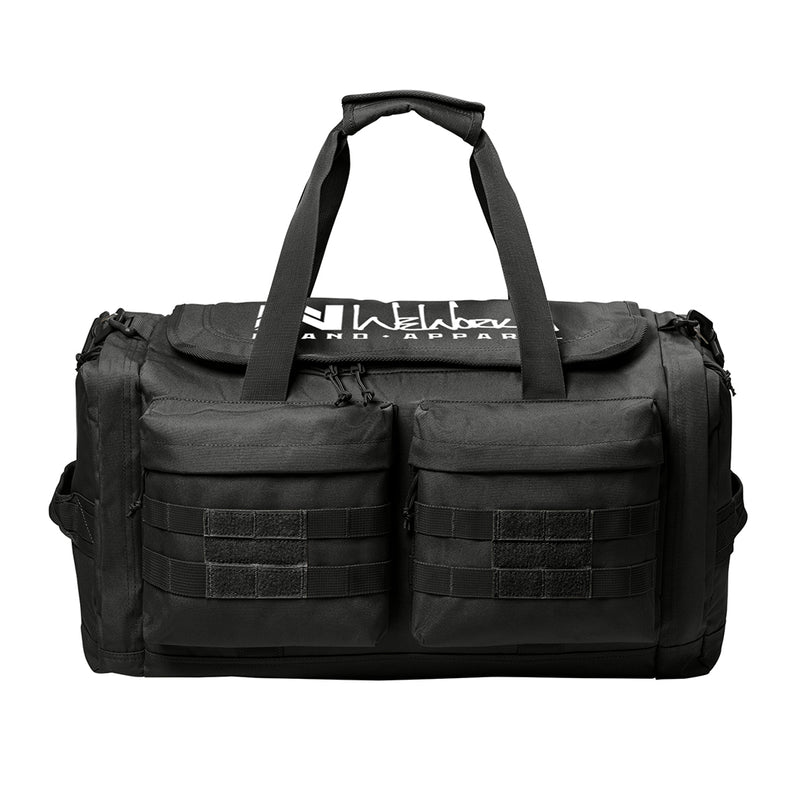 Stealth Black tactical duffle bag pictured from front on a white background. WW Script logo embroidered in white thread on the top panel. 600D polyester canvas, Covered zipper D-shaped main compartment, [2] zippered end pockets, [2] Front zippered pockets with daisy chain/loop panels for patches (WW patches sold separately), Web carry handles with padded handle wrap, Web grab handles on both ends, Removable/adjustable padded shoulder strap.