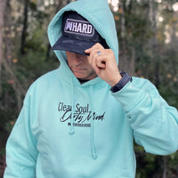 Man pictured from front in woods. He is wearing the medium-weight mint teal long-sleeve hooded sweatshirt. Printed with the tagline "Clean Soul. Dirty Mind.", centered on the front upper chest in black ink. (Also wearing a WW HARD Flexfit Black Camo Hat)