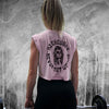 Woman pictured from back wearing a Women’s cropped muscle tee in pink. Muscle tee has a WeWorkin designed graphic on back—a female "skull-style" painted face with long hair, a rose in hair over ear and tattooed “web” on shoulder. Text encircling graphic says "NO EXCUSES • NEVER NOT WORKIN" printed in black ink. All text in Medieval-style BOLD font. A WW icon small imprinted on center chest.