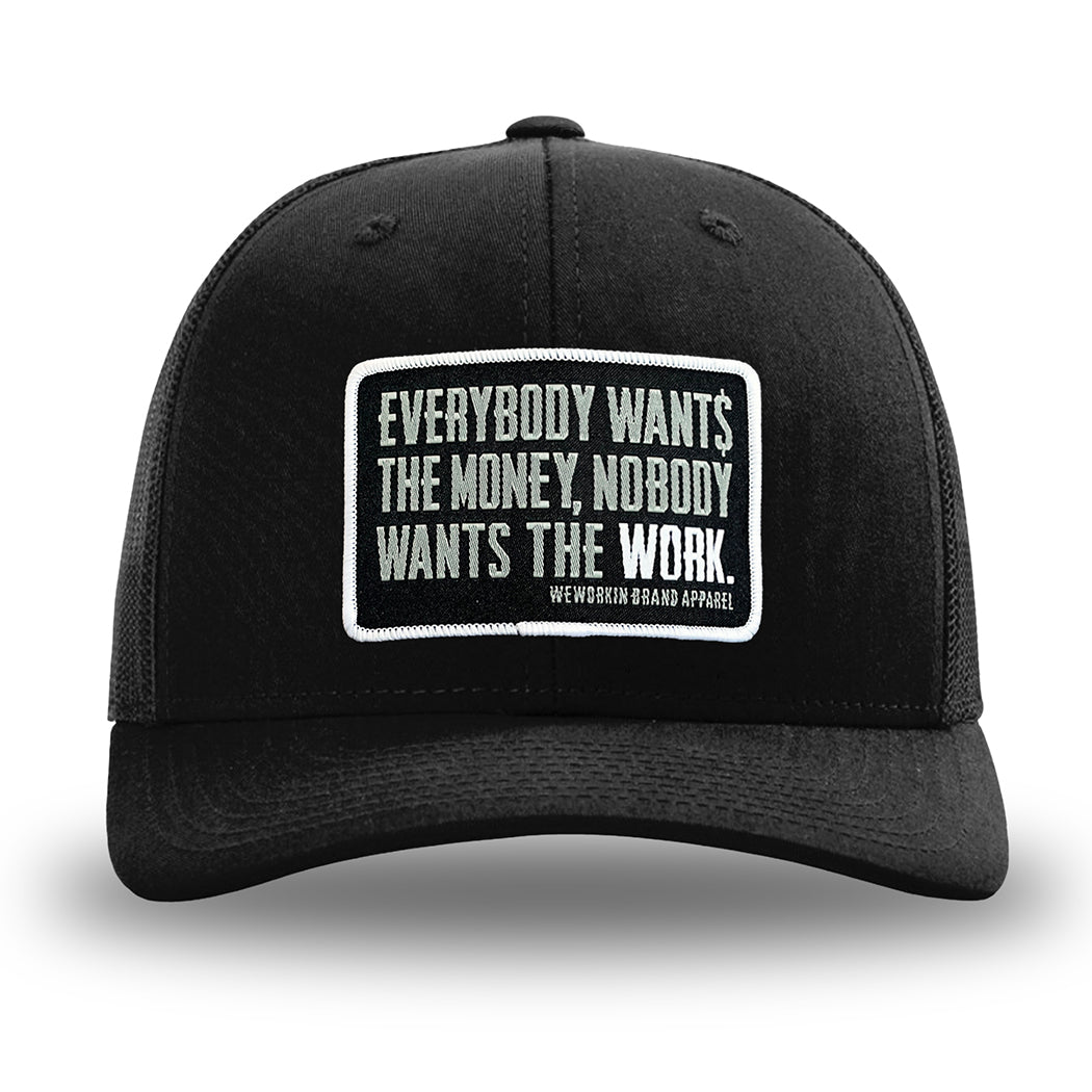 Solid Black WeWorkin hat—Richardson 112 brand snapback, retro trucker classic hat style. "Everybody Want$ the Money, Nobody Wants the WORK." patch is centered on the front panels.