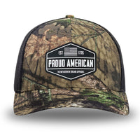 Mossy Oak/Country DNA/Black WeWorkin hat—Richardson 112 brand snapback, retro trucker classic hat style. WeWorkin black and white "PROUD AMERICAN" silicone patch is centered on the front panels.