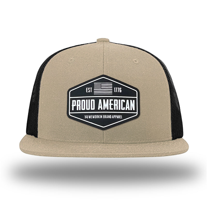 Khaki/Black WeWorkin hat—Richardson 511 brand snapback, flatbill trucker hat style. WeWorkin black and white "PROUD AMERICAN" silicone patch is centered on the front panels.