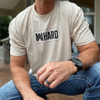 Man pictured from front wearing a WW Desert Sand color Graphic Tee. WW HARD "patch-style" graphic printed in black and white, on center chest.