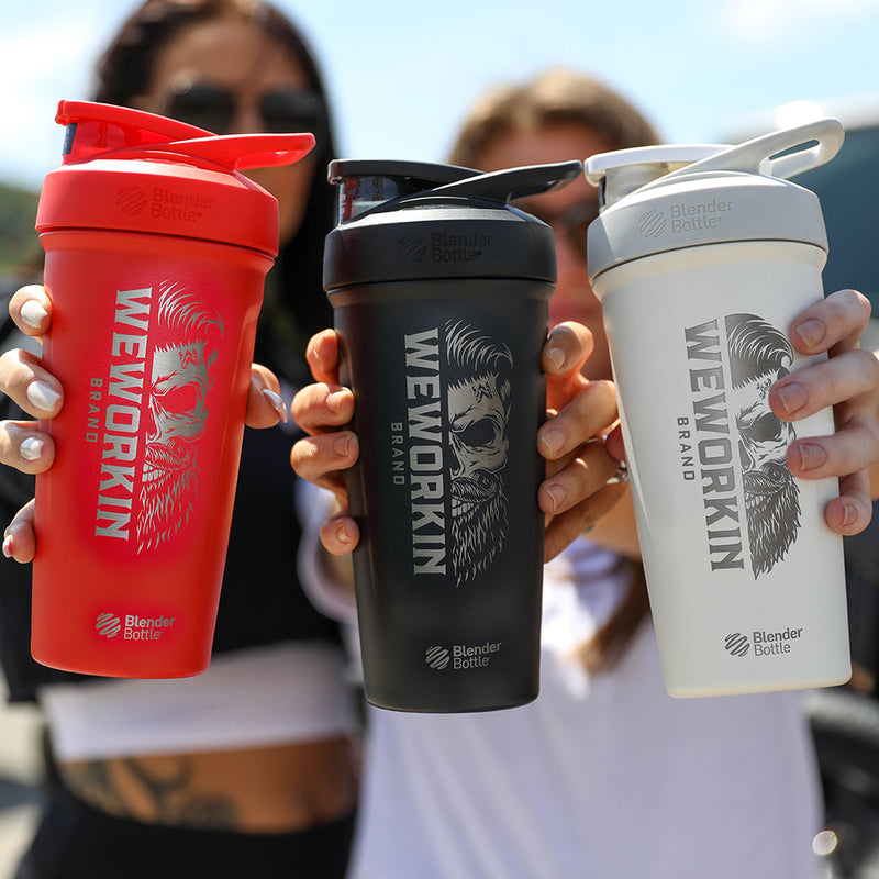 (3) Women holding the WeWorkin Red, Black and White Stainless Steel BlenderBottles® with WeWorkin Brand icon vertically etched in large size on sides—BlenderBottle® logo etched small below WW skull graphic..