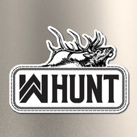 WW HUNT die-cut sticker placed on a brushed metal background. Our newest design, a WW HUNT and ELK image in our signature "patch" style (WW icon/text/elk graphic, outer "stitch" outline, inner "rope" design, all in black ). Made to last in the relentless outdoors. (Sticker measures approximately 4.5"W x 3.25"H)