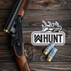 WW HUNT die-cut sticker, wooden table and shotgun/shells in background. Our newest design, a WW HUNT and ELK image in our signature "patch" style (WW icon/text/elk graphic, outer "stitch" outline, inner "rope" design, all in black ). Made to last in the relentless outdoors. (Sticker measures approximately 4.5"W x 3.25"H)