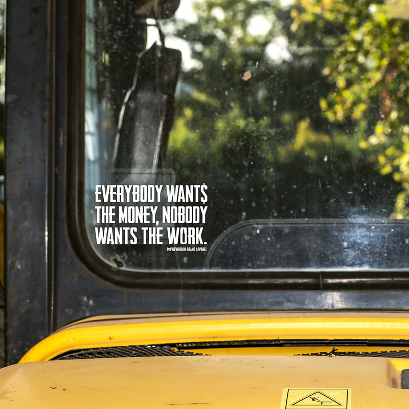 Small WEWORKIN BRAND "EVERYBODY WANT$ THE MONEY..." white Decal—Custom die-cut Direct Transfer decal/sticker on the window of an older piece of heavy equipment.