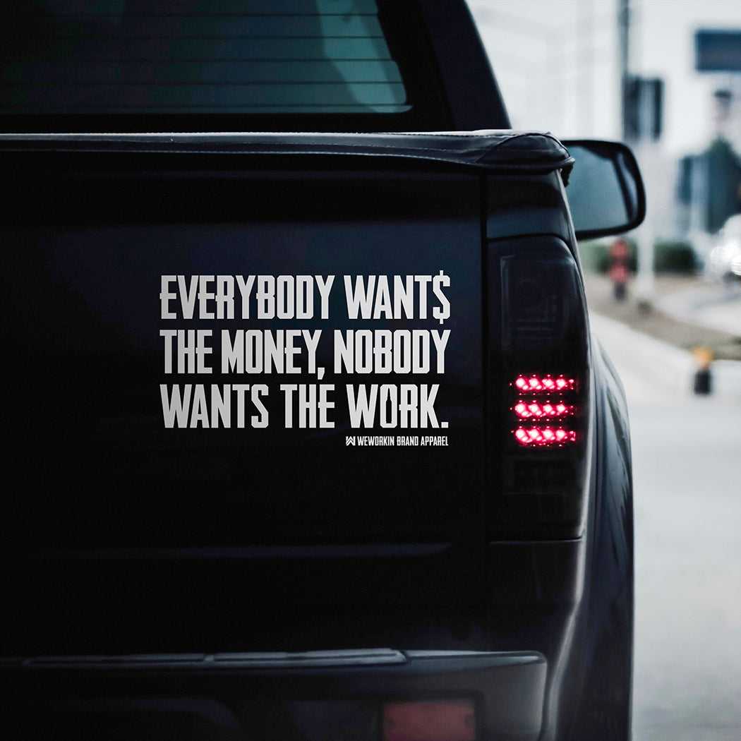 Large WEWORKIN BRAND "EVERYBODY WANT$ THE MONEY..." white Decal—Custom die-cut Direct Transfer decal/sticker on the tailgate of a black pickup truck.